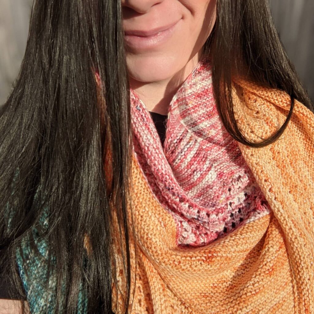 bottom half of woman's face wearing a hand dyed handknit shawl